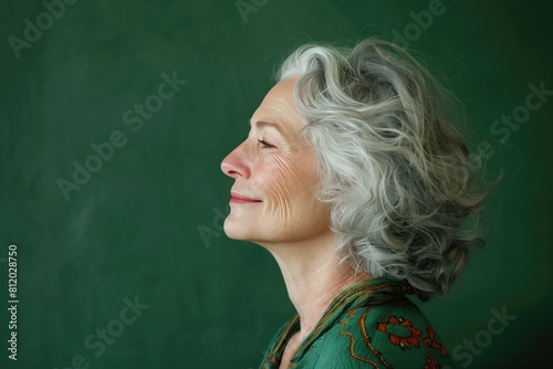 Radiant senior woman with a gentle smile, stylish attire, Joyful Senior Woman Enjoying Moment