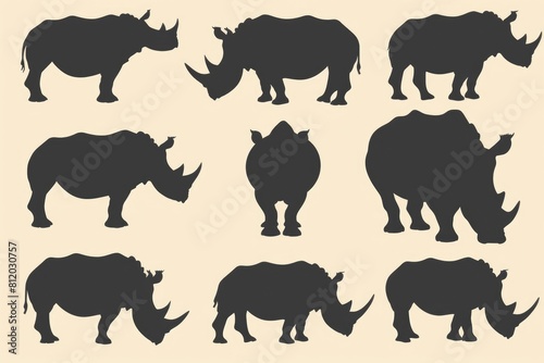 Silhouettes of rhinos on a neutral beige backdrop. Perfect for wildlife or safari themed designs