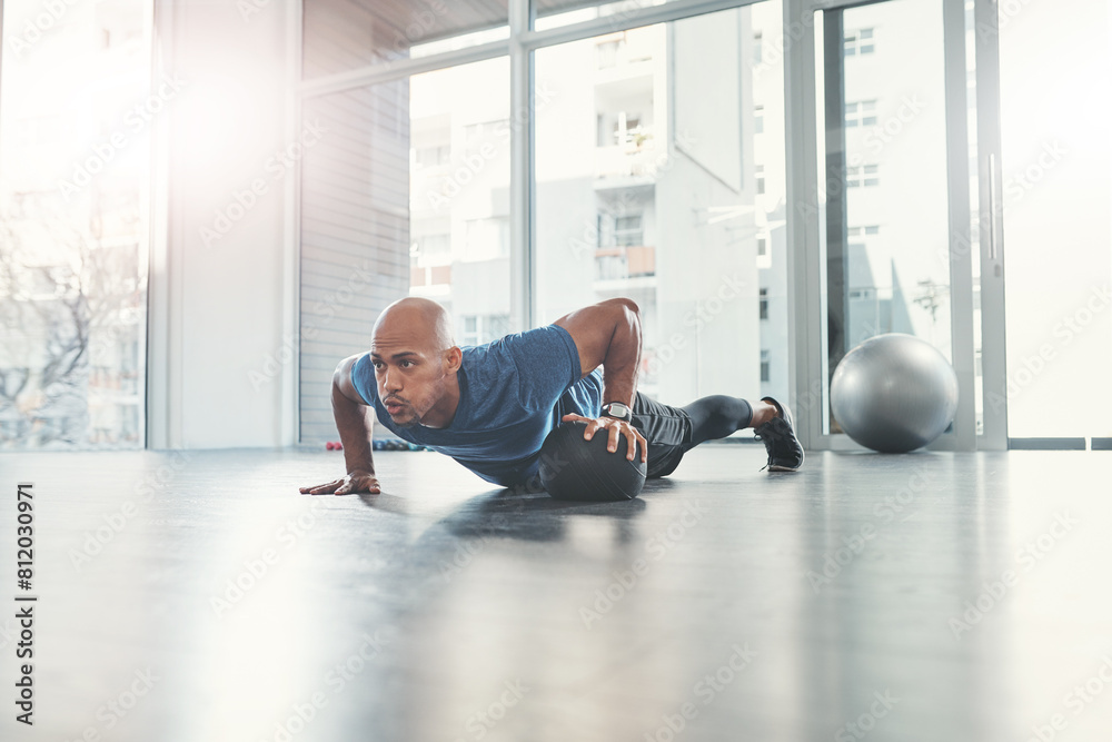 Man, push up and medicine ball in gym for fitness, health and wellness, athlete and workout. Exercise, strong and bodybuilder in sport centre for body care, performance and endurance training Man, push up and medicine ball in gym for fitness, health and wellness, athlete and workout. Exercise, strong and bodybuilder in sport centre for body care, performance and endurance training