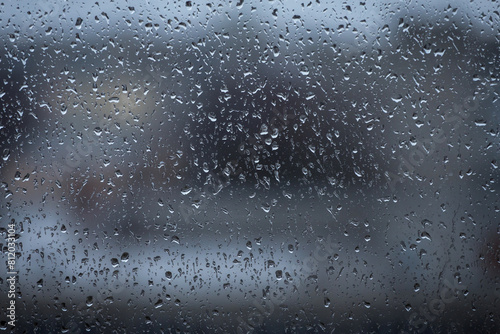 Rain drops on window glass closeup macro. Blue Abstract background texture with rain drop