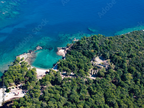 Fototapeta Naklejka Na Ścianę i Meble -  Aerial Panorama of the Historic Phaselis Ruins Amidst Lush Forests in Antalya, Turkey