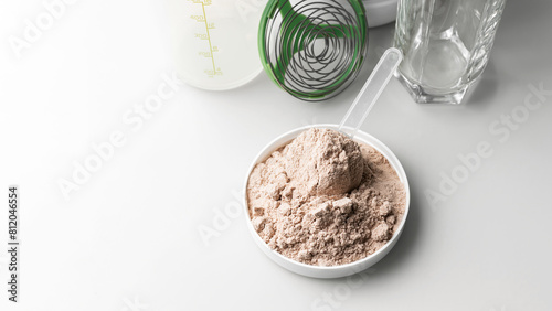 Whey protein powder in measuring scoop
