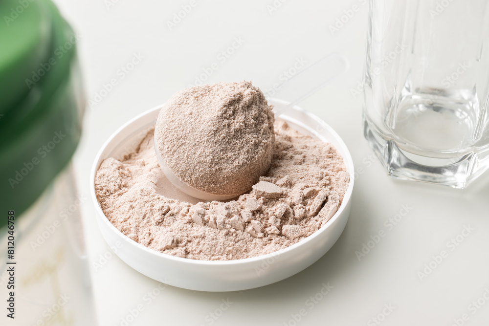 Whey protein powder in measuring scoop Whey protein powder in measuring scoop
