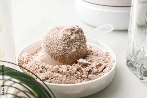 Whey protein powder in measuring scoop © O.Farion