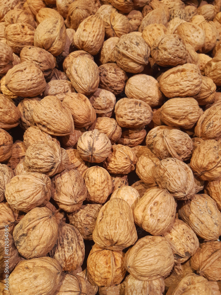 Natural nuts in shell background. Bulk dried fruits. Whole unpeeled walnuts. many nuts in the market. Healthy and organic food. Natural fresh walnut full frame. Natural nuts in shell background. Bulk dried fruits. Whole unpeeled walnuts. many nuts in the market. Healthy and organic food. Natural fresh walnut full frame.