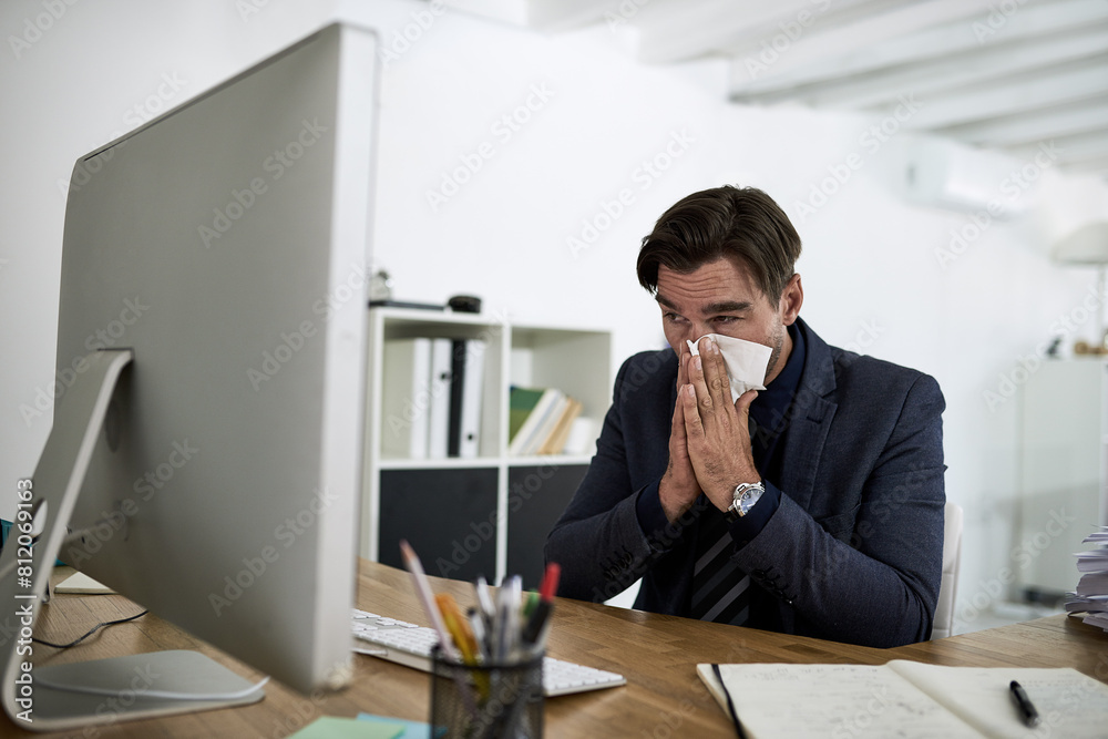 Sinus, sneeze and business man in office with allergies, blowing nose and virus working at desk. Corporate worker, healthcare and person with tissue for illness, cold and flu sneeze in workplace Sinus, sneeze and business man in office with allergies, blowing nose and virus working at desk. Corporate worker, healthcare and person with tissue for illness, cold and flu sneeze in workplace