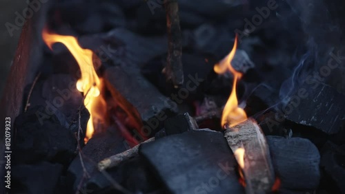 Slow motion shot of charcoal in brazier, preparation for bbq