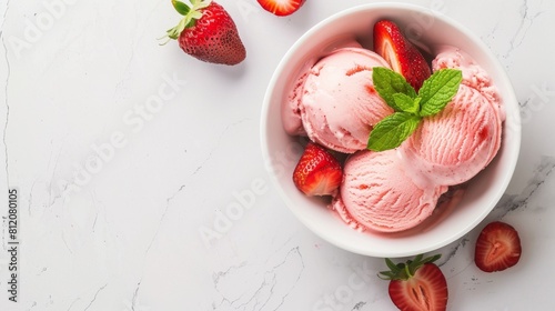 Delicious strawberry ice cream in a bowl on white marble table, strawberries on the table