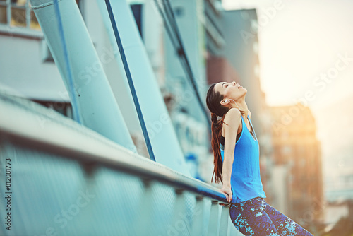 Runner, fitness and woman in city, tired and exhausted with challenge, rest and urban town. Person, girl and athlete with fatigue, wellness and healthy with running progress, breathing and peaceful photo