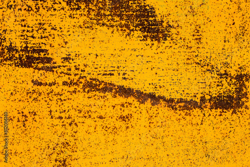 Orande rusty abstract painted metal background. Yellow texture of old plate with brown rust photo