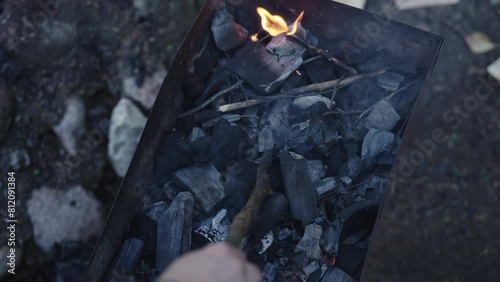 Slow motion shot of charcoal in brazier, preparation for bbq