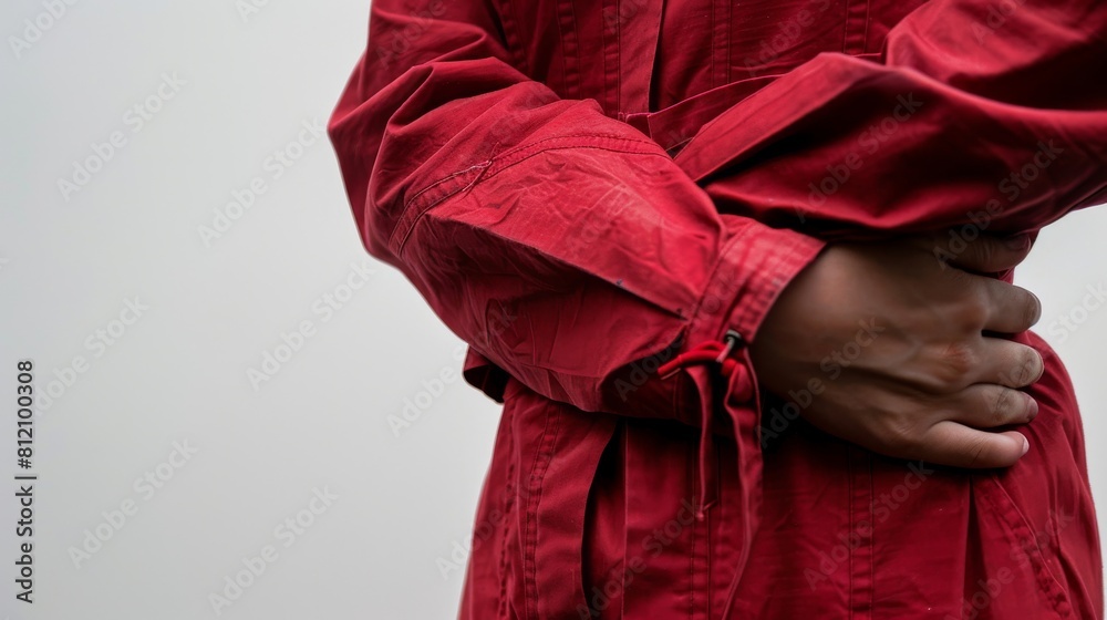 Detail shot of a patients torso in a crimson patient suit, emphasizing the rich color against a minimalist white backdrop Detail shot of a patients torso in a crimson patient suit, emphasizing the rich color against a minimalist white backdrop