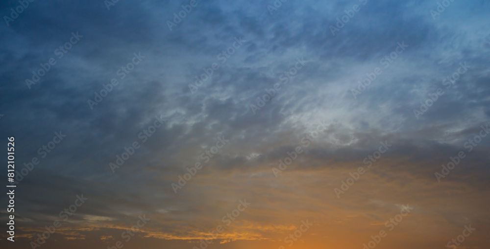 Blue sky with cirrus clouds and sunrise. Wide photo.