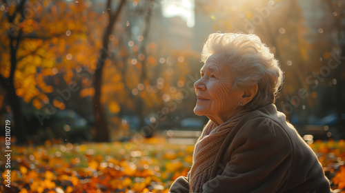 Elderly woman enjoying the warm sunlight in a park with autumn leaves. Golden age and peaceful retirement concept. Design for poster, banner ,gennerlative ai