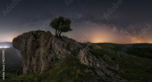 panoramic view of the Milky Way the Portupekoleze arch in the Urbasa Natural Park, Navarra with a starry sky photo