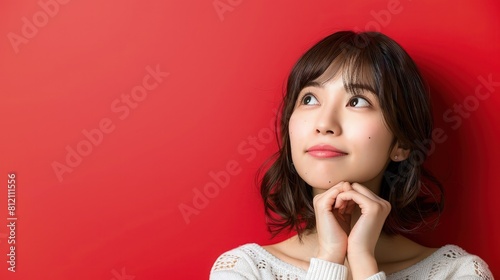 A Japanese girl's gaze is distant yet focused, her mind clearly preoccupied with thoughts and ideas