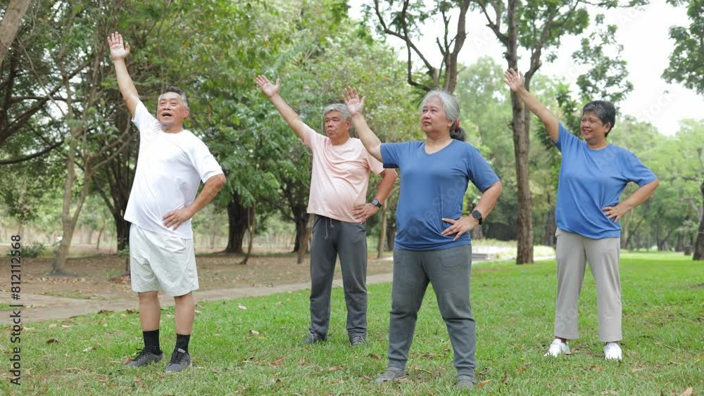 Group of elderly Asians exercising outdoors in a garden outside. They warm up before exercising. Health care. Elderly society. sports concept Group of elderly Asians exercising outdoors in a garden outside. They warm up before exercising. Health care. Elderly society. sports concept