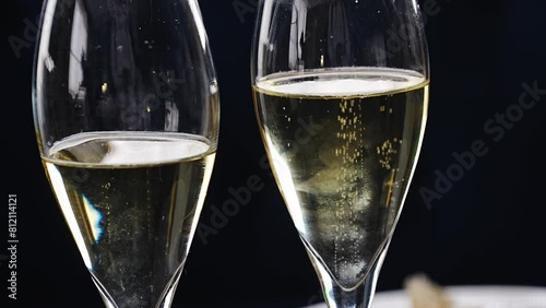 Bubbles rise from the bottom of a champagne glass. 