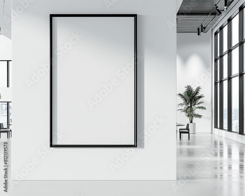 Modern architecture firm with one large blank poster in a professional black frame spotlighted on a sleek white wall for architectural project advertisements or design concepts