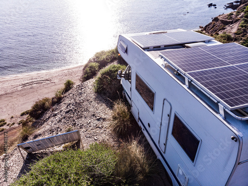 Caravan with solar panels on roof camp on sea, Spain. Aerial view. © Voyagerix