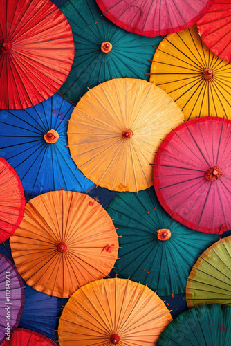 A festive display of colorful umbrellas against a clear summer sky