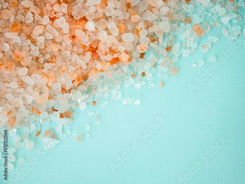 The texture of pink Himalayan salt is scattered in large crystals on a blue background. A place for the text