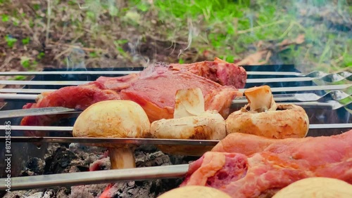 Juicy meat on a woodfired grill, barbecuing in 4K detail, at an adventurous food setting. photo