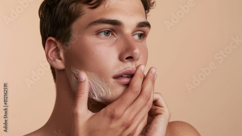 Young Man Applying Facial Cream