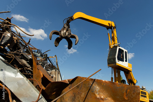 Excavator for loading scrap metal.