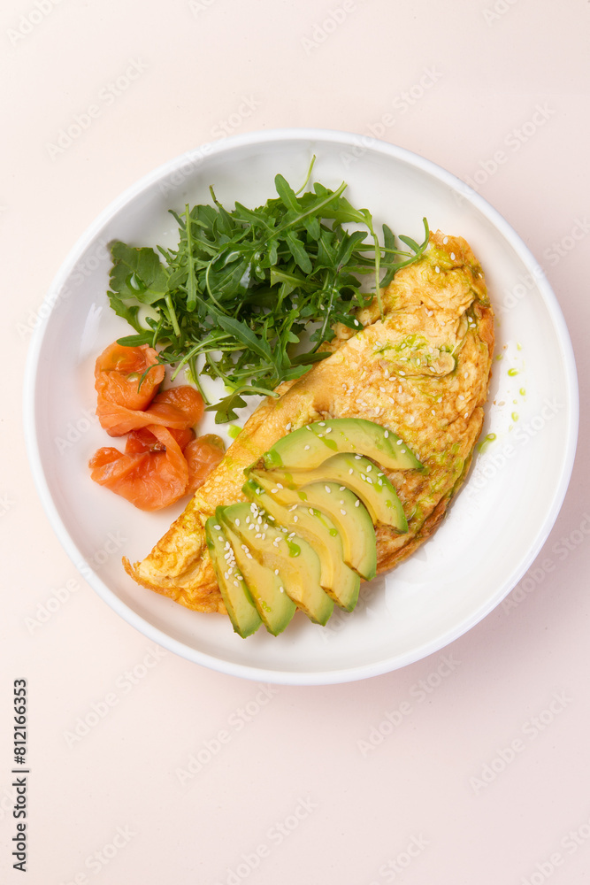 Scrambled eggs, avocado and greens in a plate. Scrambled eggs, avocado and greens in a plate.