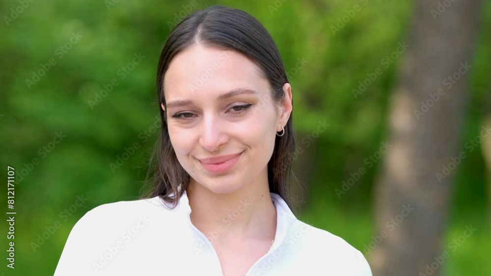 A beautiful woman showing emotions in the park. Slow motion. A beautiful woman showing emotions in the park. Slow motion.
