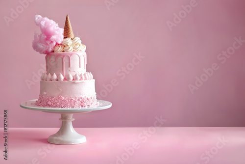 two tier pink birthday cake on pink  background 