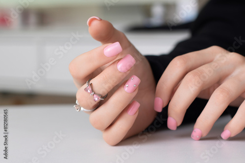 Beautiful female hands with pink manicure nails
