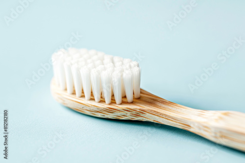 Eco-friendly realm with a close-up of a bamboo toothbrush on pastel blue background