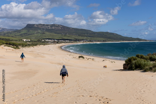 People relaxing on the beach at Punta Paloma on the seashore  of the Atlantic in Spain on a bright sunny day