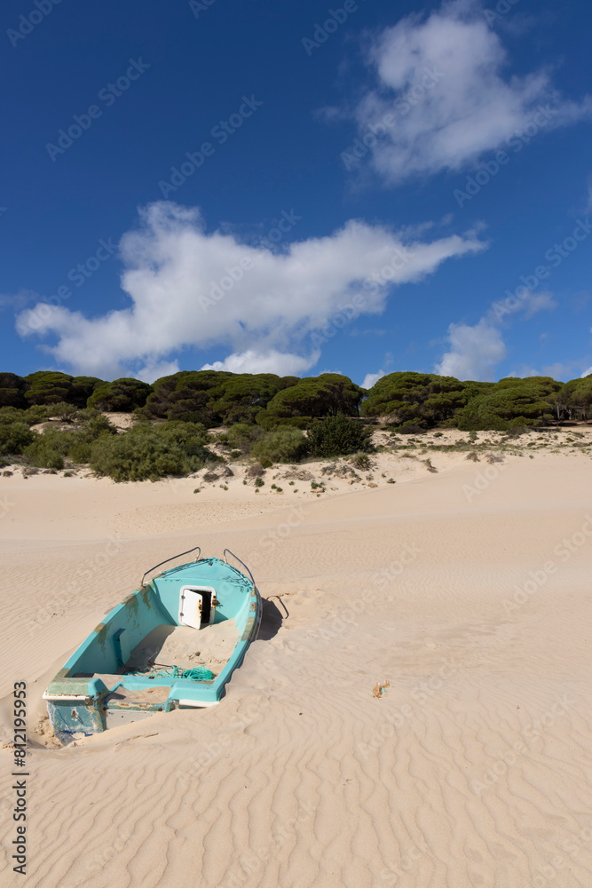 Fishing boat on the sand beach next to ocean at Punta Paloma in Spain on a bright sunny day Fishing boat on the sand beach next to ocean at Punta Paloma in Spain on a bright sunny day