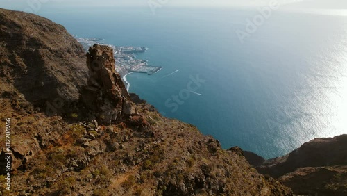 Scenic landscape of Los Gigantes cliffs in Tenerife with view of the town Puerto Santiago. Endless ocean horizon. photo