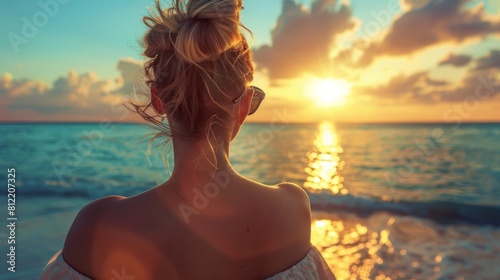 A captivating scene of a woman observing the beautiful sunset by the serene seaside