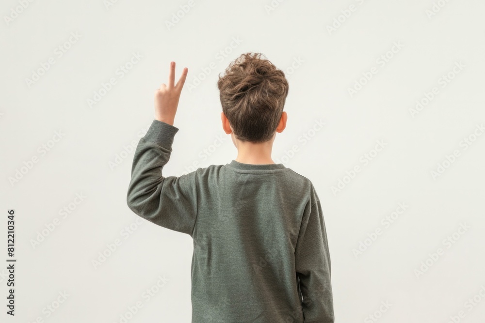 Back view of a boy with his hand up on a white background. Generative AI. Back view of a boy with his hand up on a white background. Generative AI.