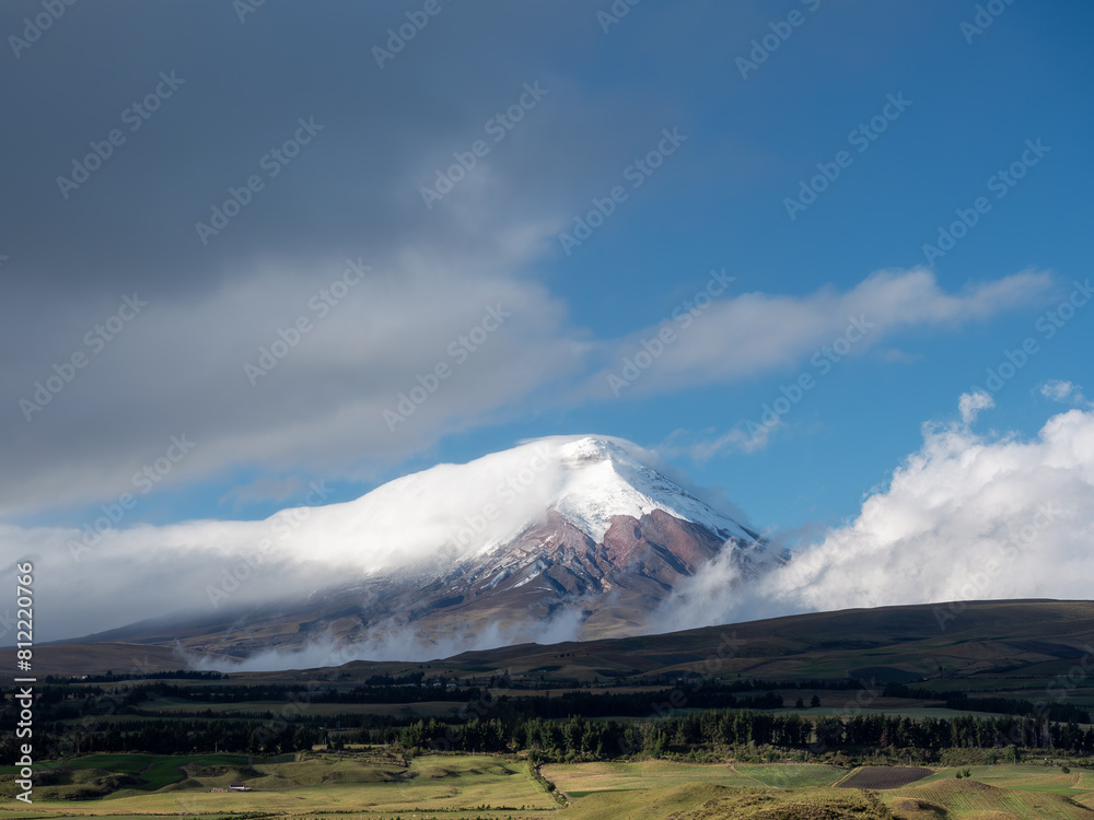 Fototapeta premium Landscape Cotopaxi volcano in Ecuador covered with clouds during a sunny day