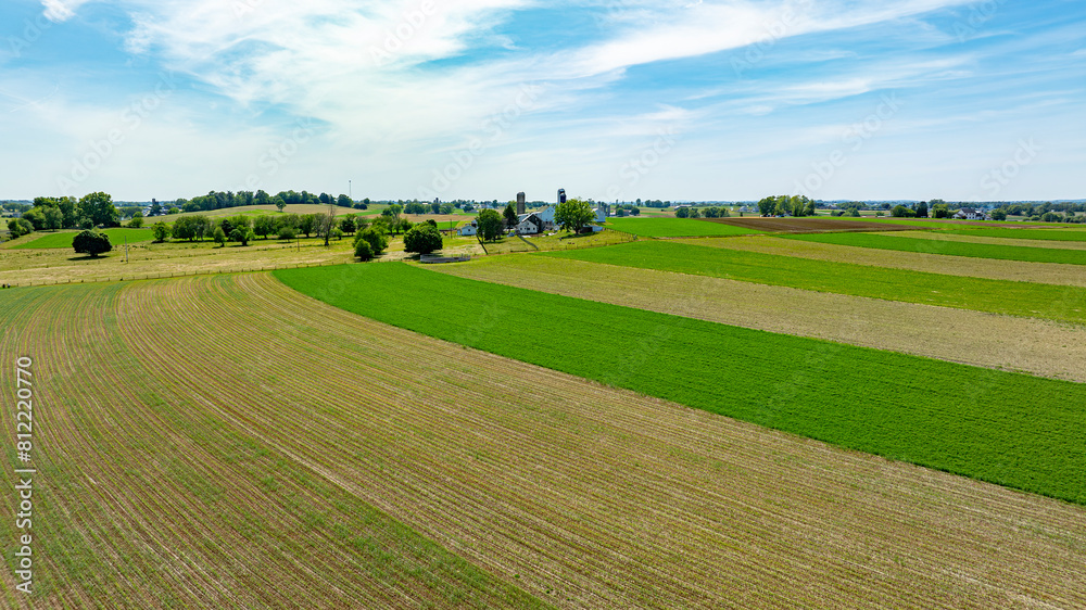 Overhead view of rural landscape, neatly divided green and plowed fields next to farm buildings, Overhead view of rural landscape, neatly divided green and plowed fields next to farm buildings,