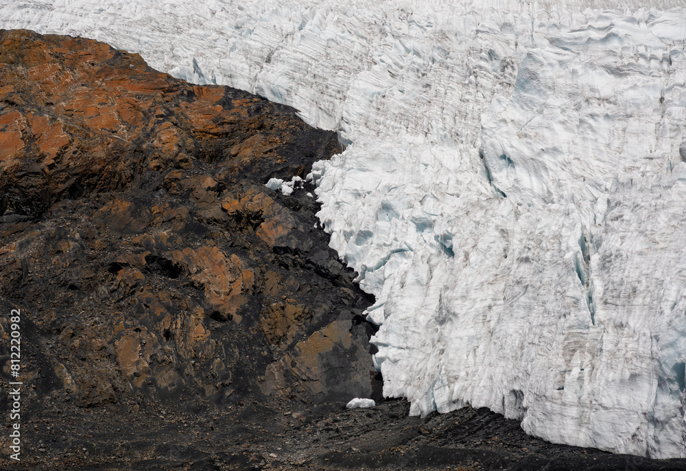 Fototapeta premium Detail of a glacier on a rocky mountain surface retreating