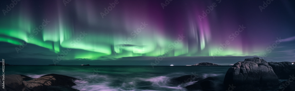 Northern Lights over a lighthouse in the ocean with big waves.