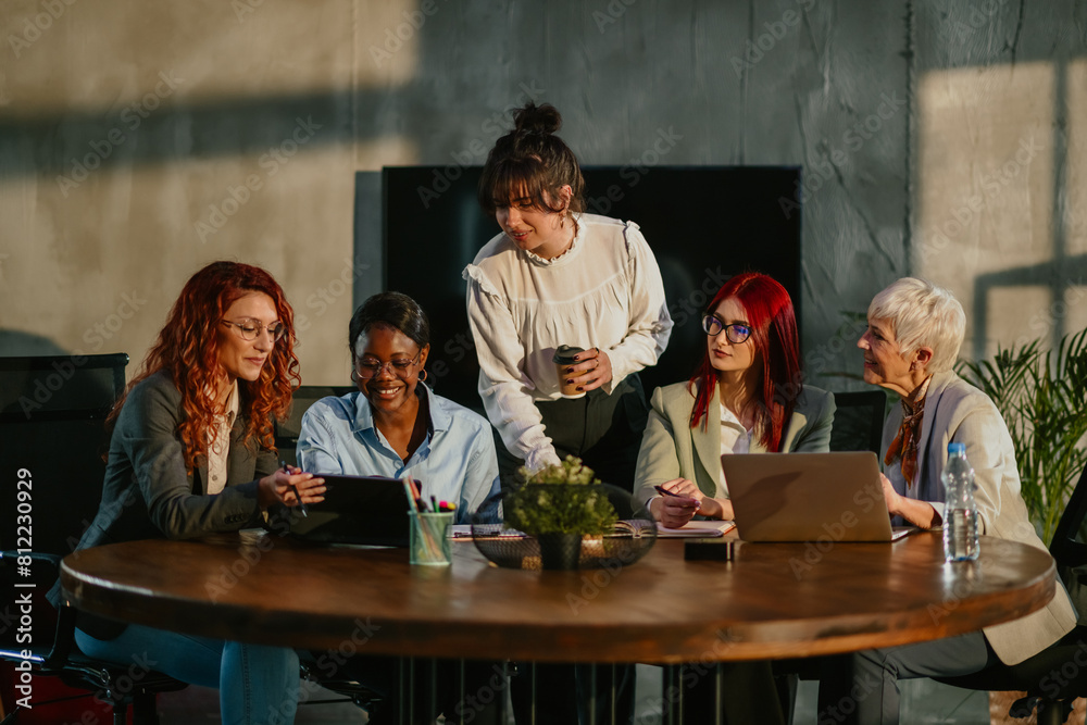 Diverse female team brainstorming and collaborating on a project. Diverse female team brainstorming and collaborating on a project.