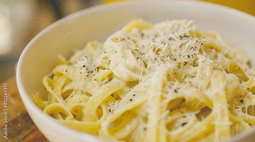Close-up of a bowl of creamy pasta with grated cheese on top Close-up of a bowl of creamy pasta with grated cheese on top