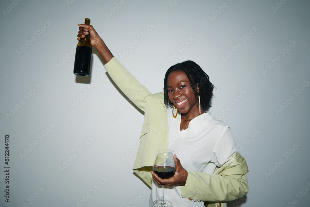 Portrait of young Black woman having bottle of red wine on Friday night Portrait of young Black woman having bottle of red wine on Friday night