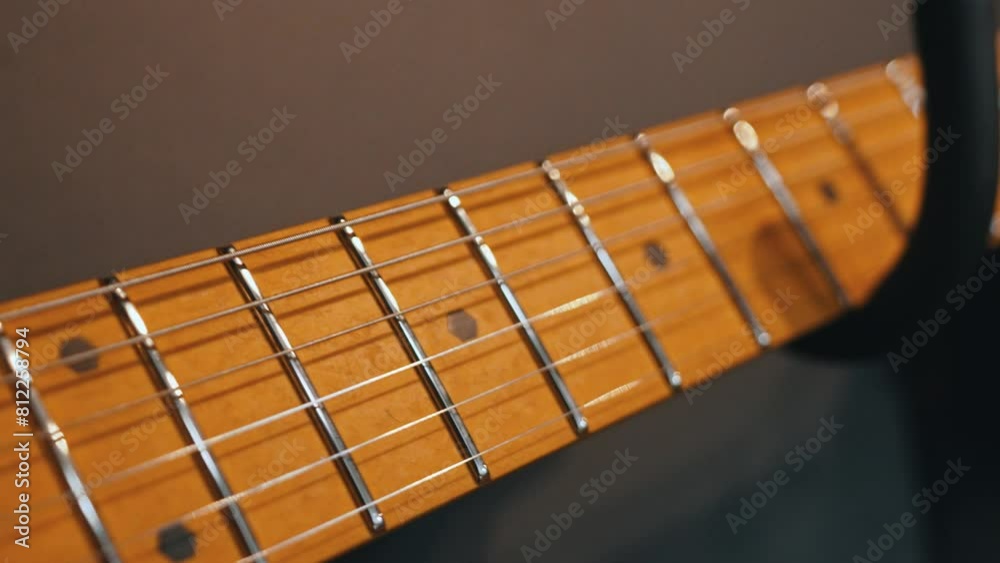 modern yellow electric guitar hanging on the wall with others, guitars shop. High quality 4k footage