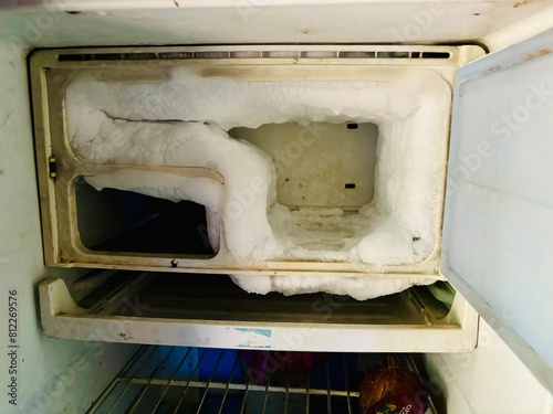 Ice dumped in freezer due to malfunction, hindering its function. Illustrates maintenance issues and need for repair. fridge complaint photo