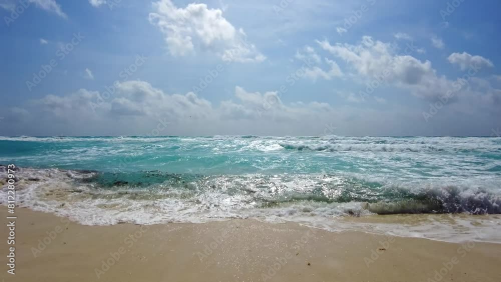 Beautiful view of the waves of the Caribbean Sea rolling onto the sandy beach. Mexico. Beautiful view of the waves of the Caribbean Sea rolling onto the sandy beach. Mexico.