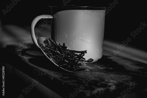 Hot tea drink in enamel cup, tea dregs in tea drink. photo